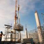 group of construction workers working with crane