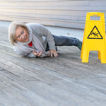 Senior woman slipping and falling on a wet surface