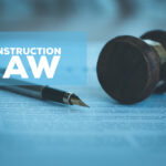 construction law caption in front of gavel, pen, and legal document