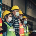 Factory workers with face mask protect from outbreak of Corona Virus Disease 2019 or COVID-19.