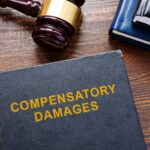 Compensatory damages law and gavel.