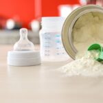 Baby milk formula on kitchen background