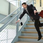 businessman falling on stairs